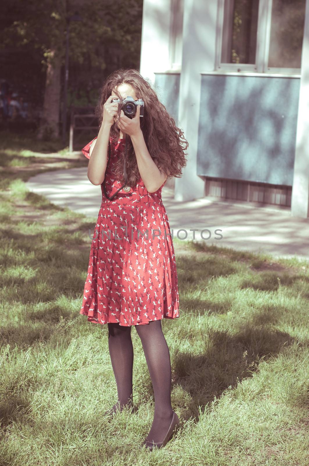 hipster vintage woman with old camera in the park