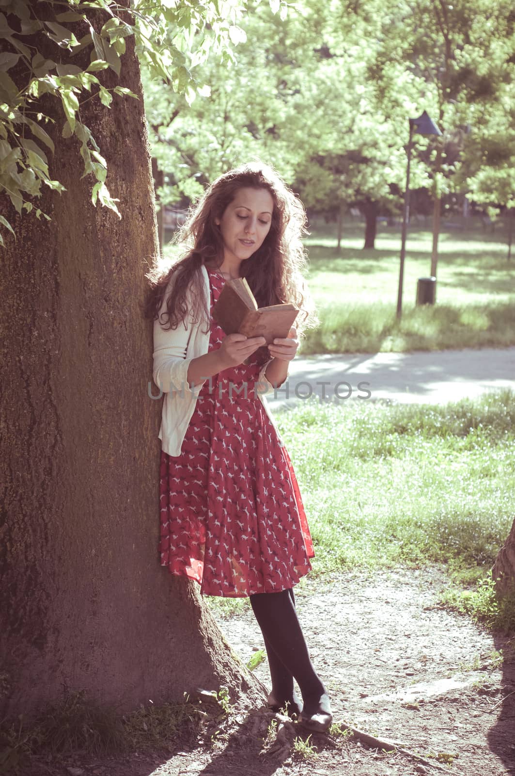 eastern hipster vintage woman reading book in the park