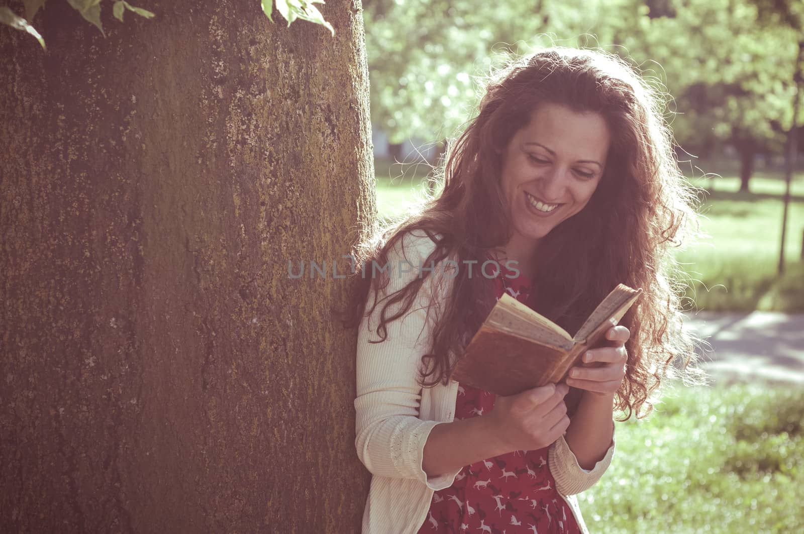 eastern hipster vintage woman reading book in the park