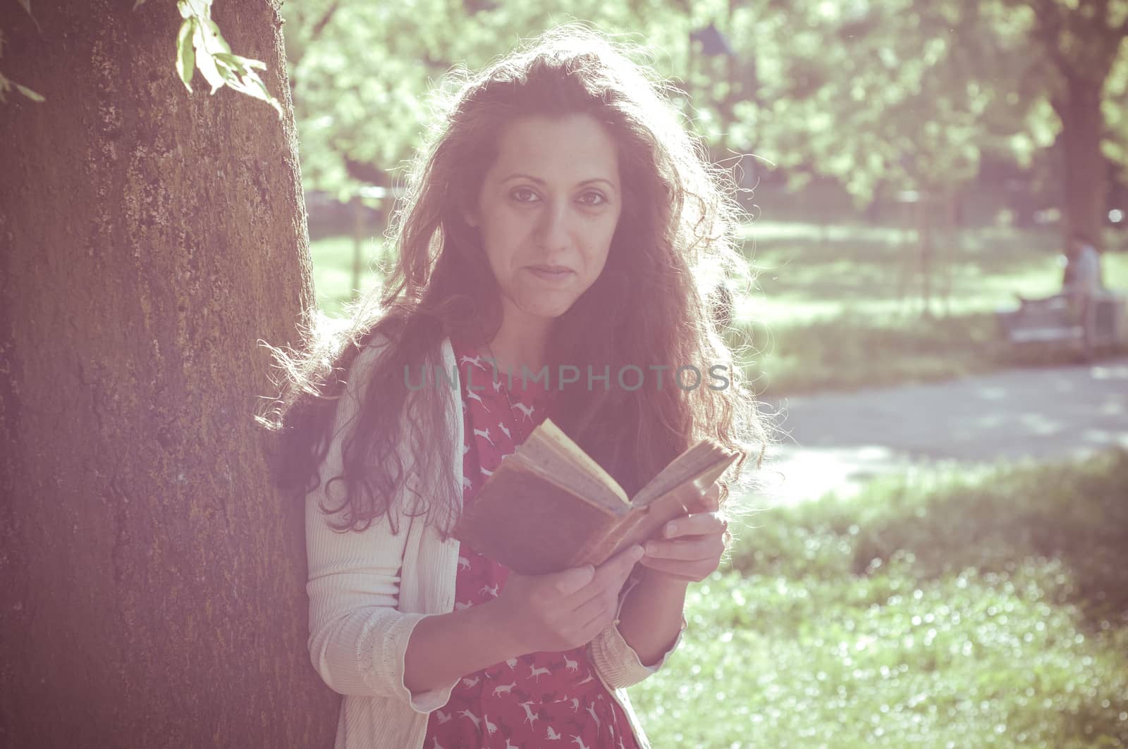 eastern hipster vintage woman reading book in the park