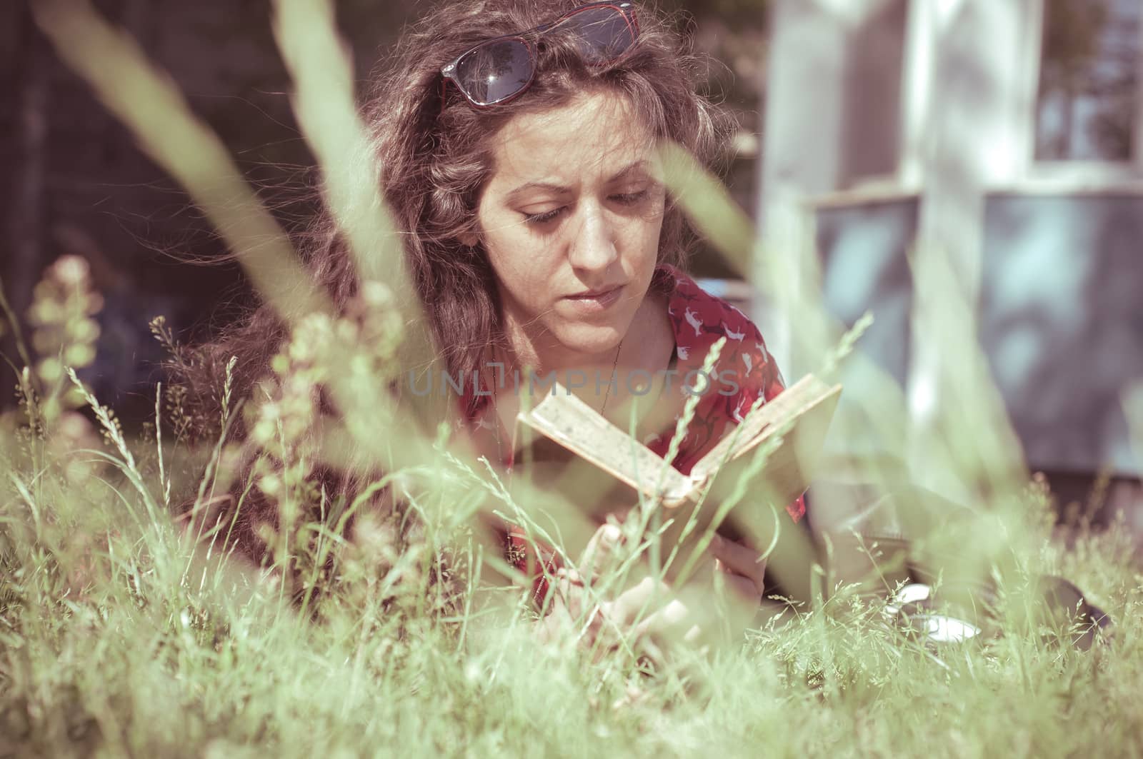 eastern hipster vintage woman reading book in the park