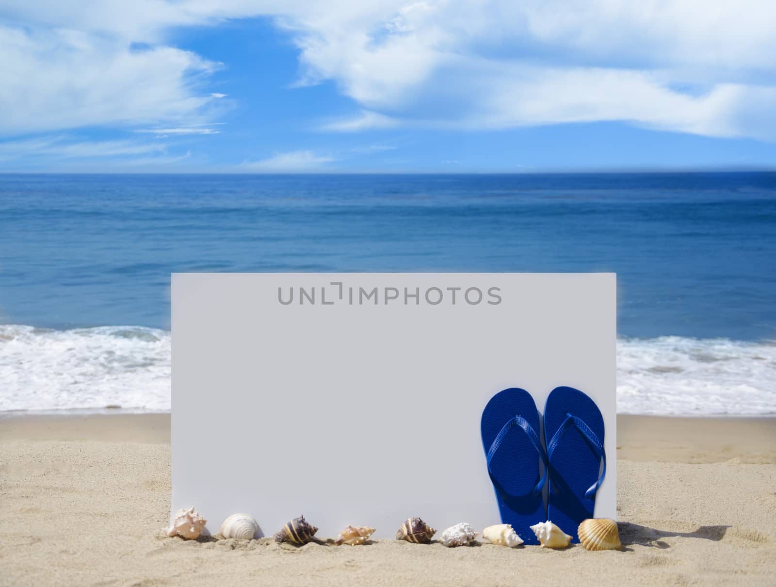 White board with flip-flops on sandy beach by EllenSmile
