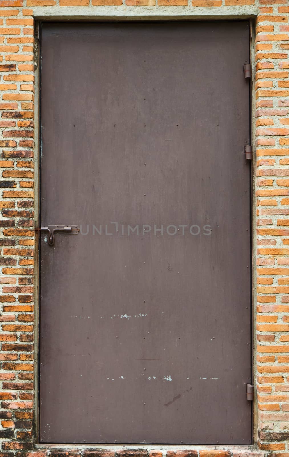 Steel door on the brick wall. by cameracantabile