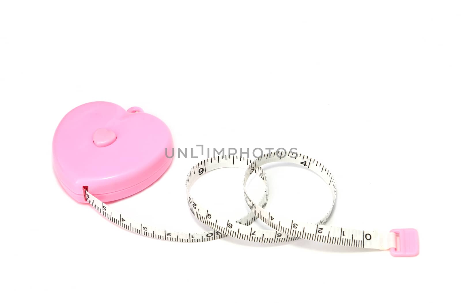 Measuring tape in a pink heart cassette isolated on white background 