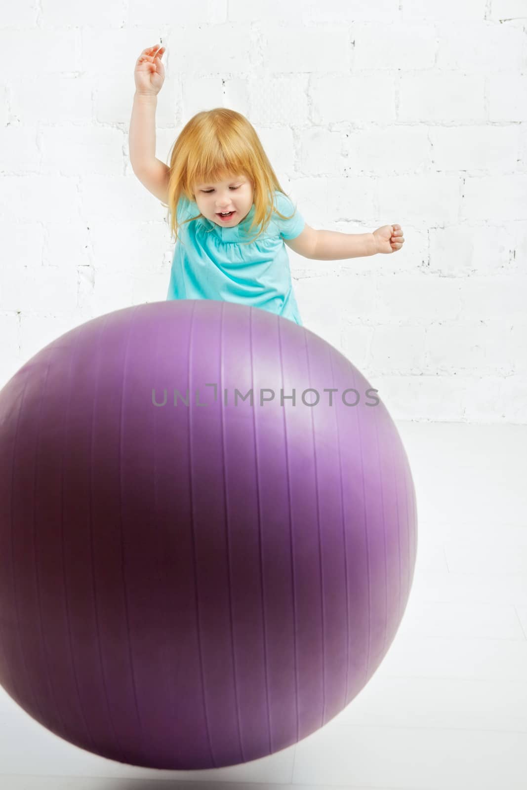 beautiful little girl playing with big ball