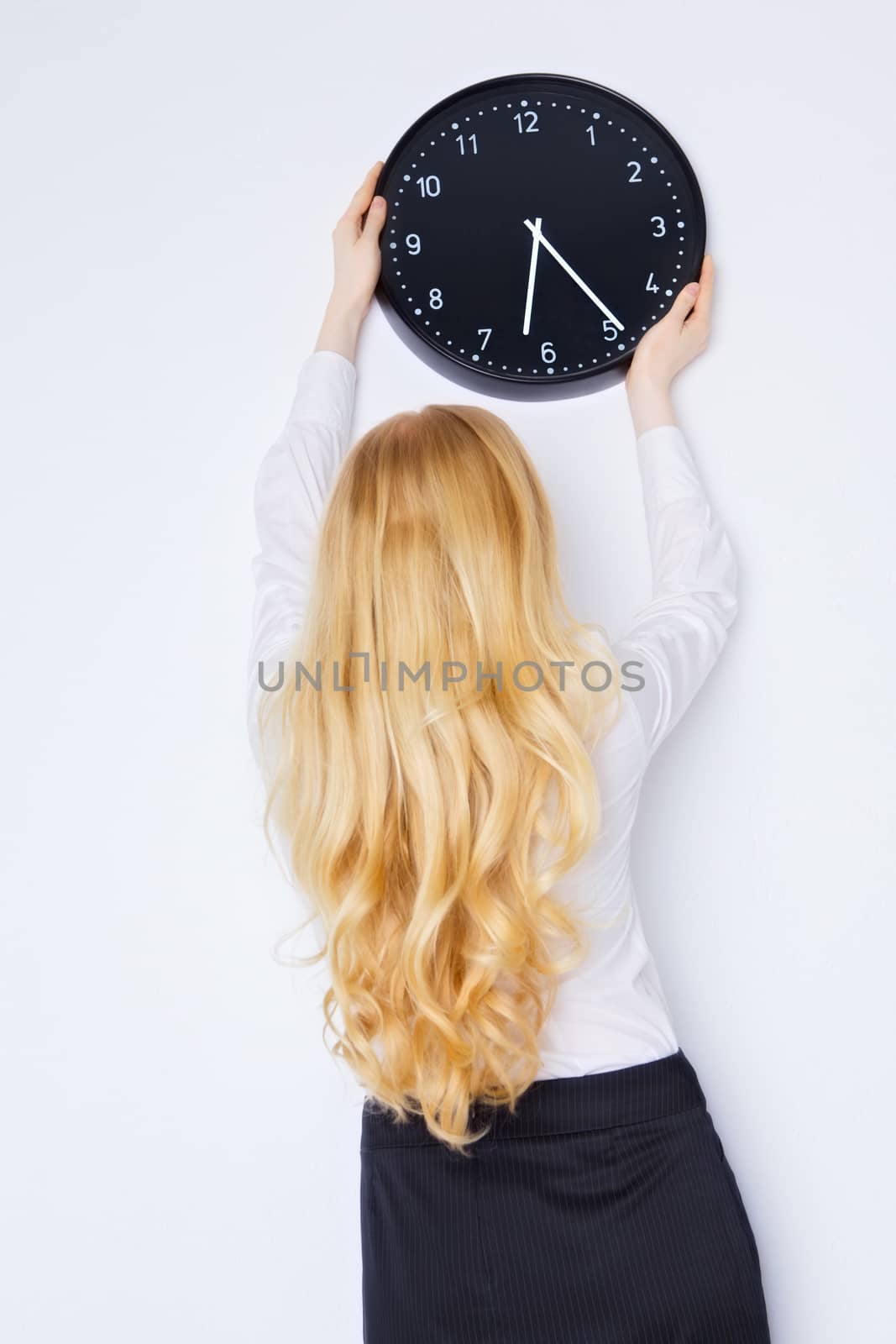 office girl sets the clock to end of work day