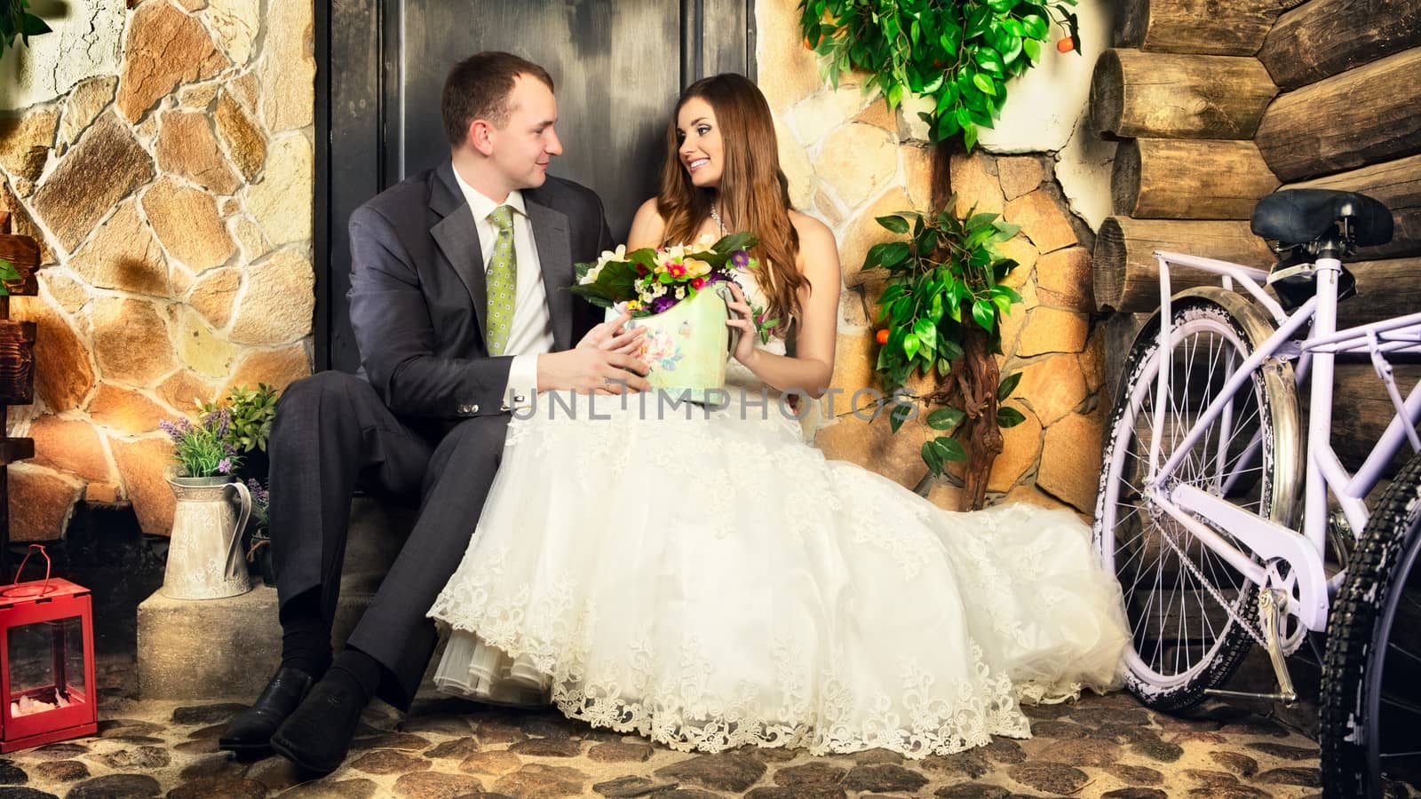 charming bride and groom on porch of house