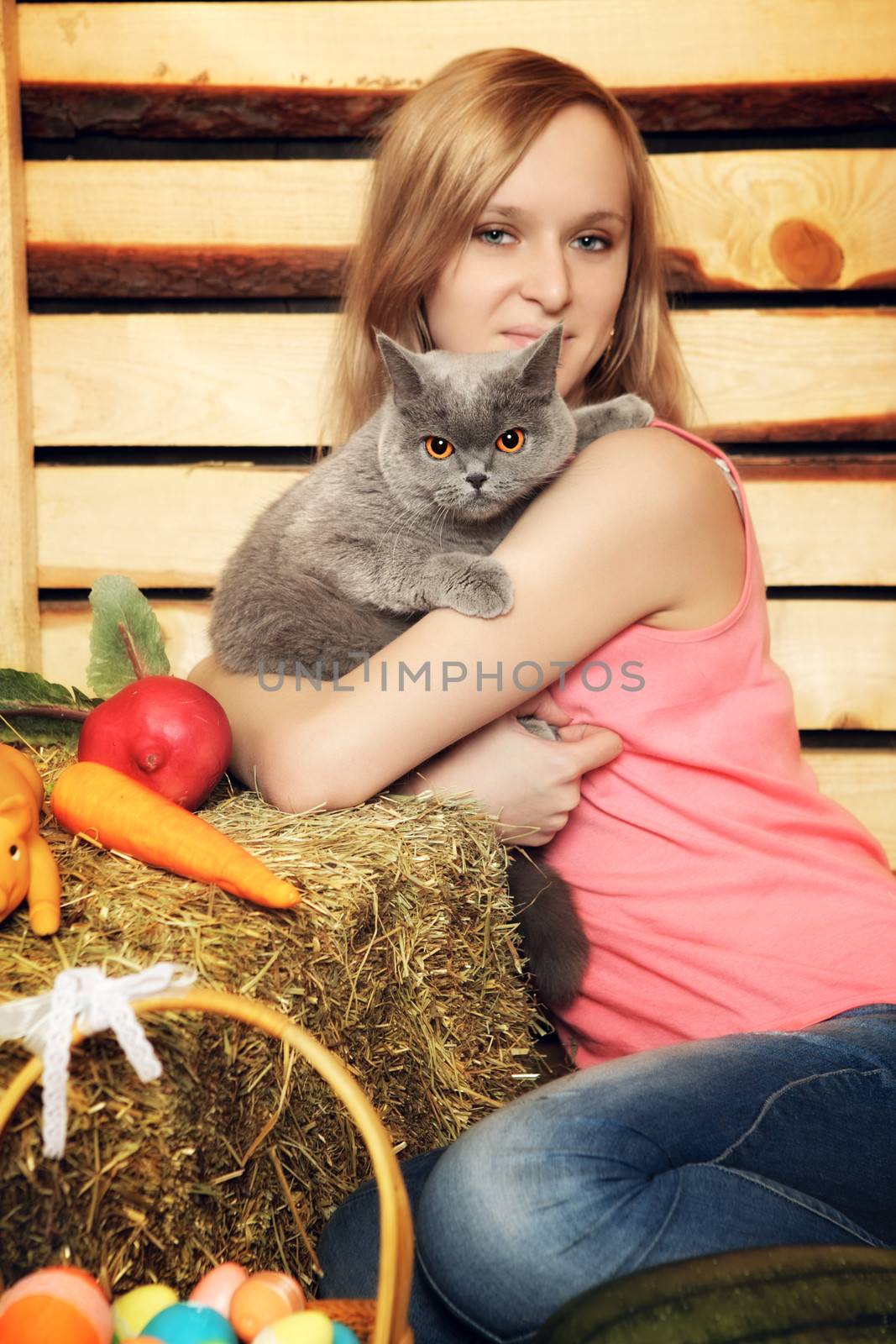 beautiful girl with cat on hayloft at summer day