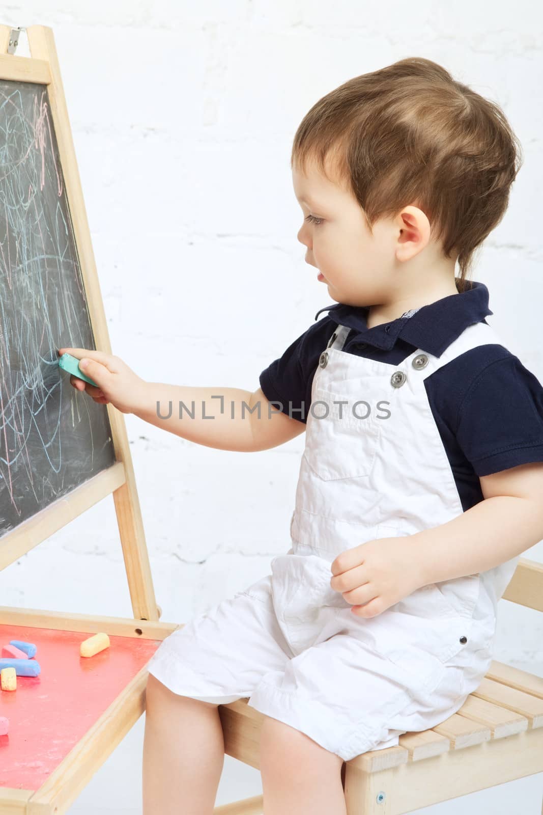 Child Drawing With Chalk by petr_malyshev