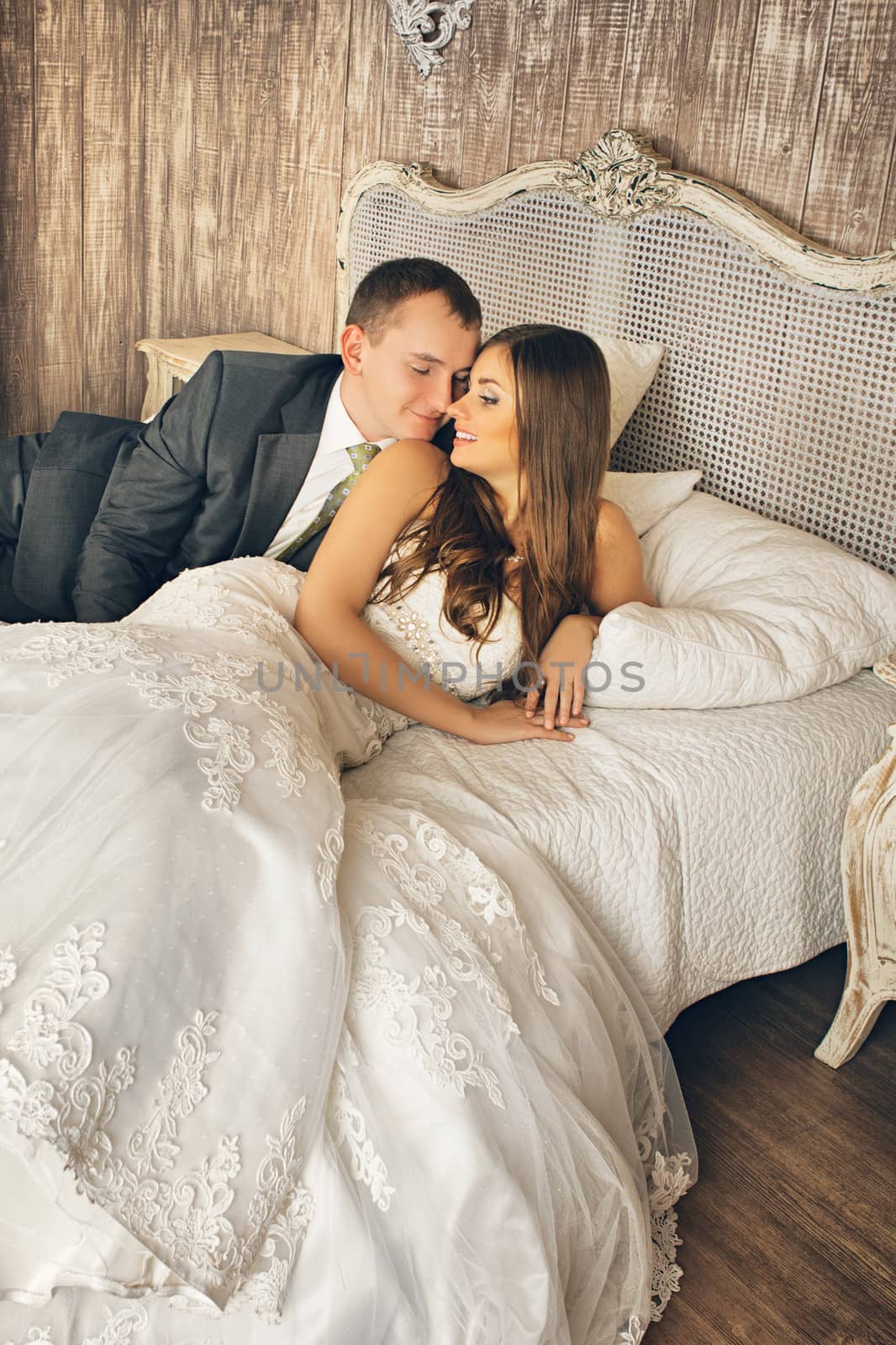 charming bride and groom in their bedroom