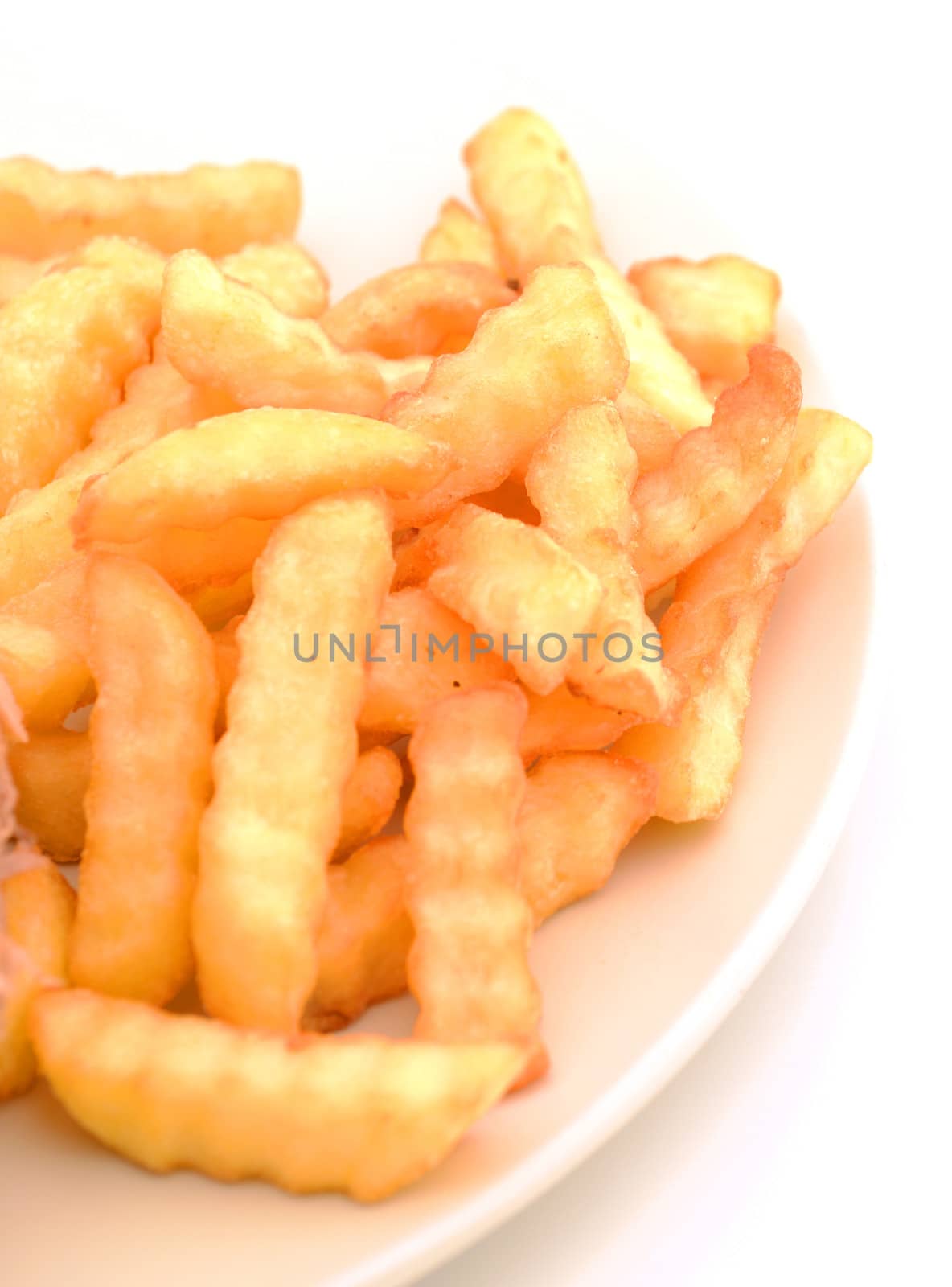 crinkle cut french fries on a plate with nobody