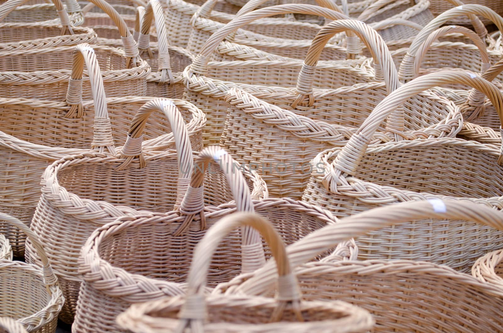 closeup of wicker handmade diy wooden basket with handle sell in outdoor city street market fair.