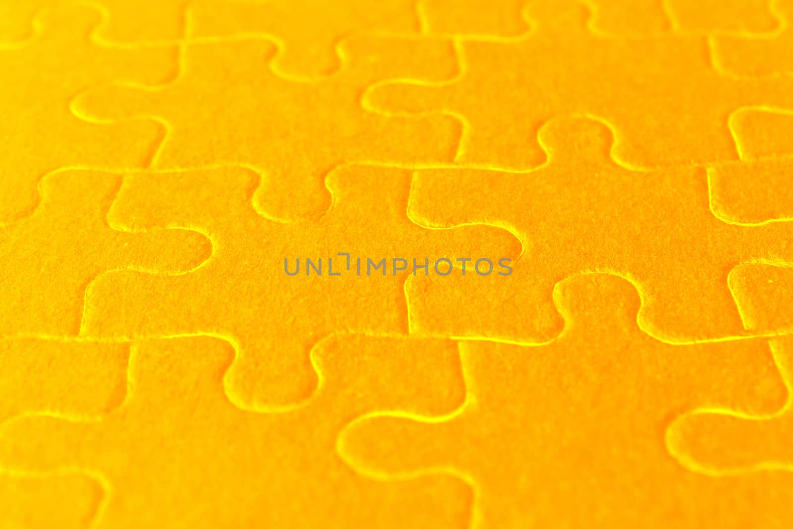 close up of orange jigsaw puzzle parts
