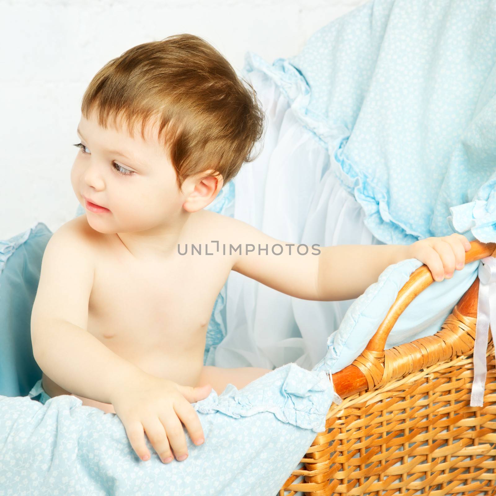 funny boy in cradle, happy and smiling