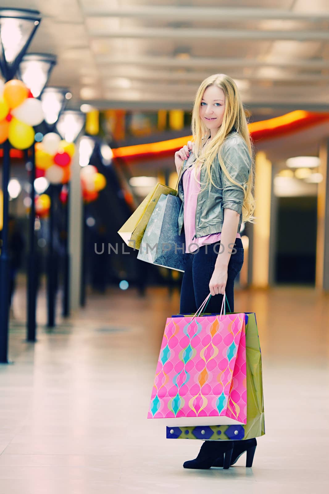 happy girl with shopping bags in shop