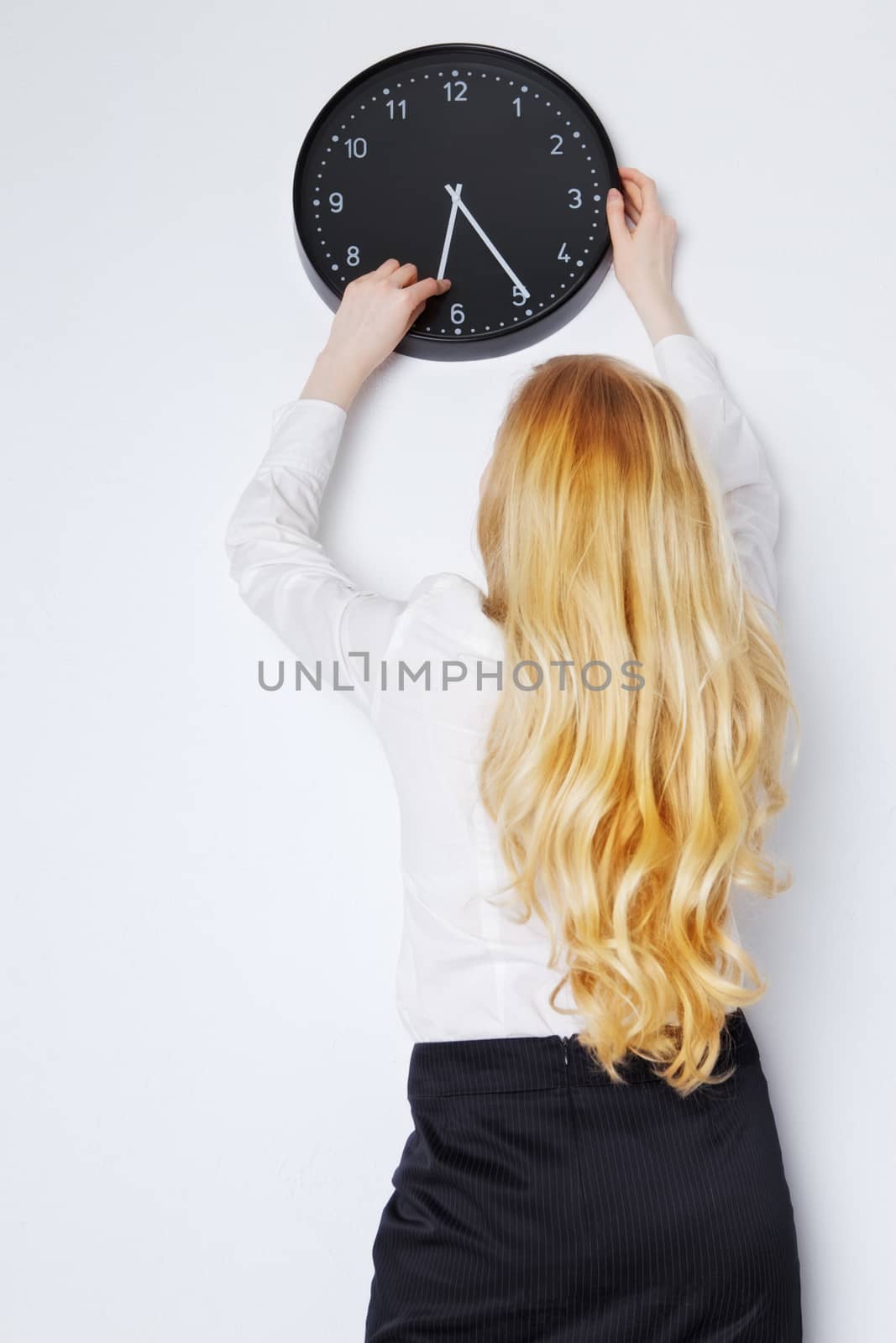 Office Girl Sets the Clock by petr_malyshev