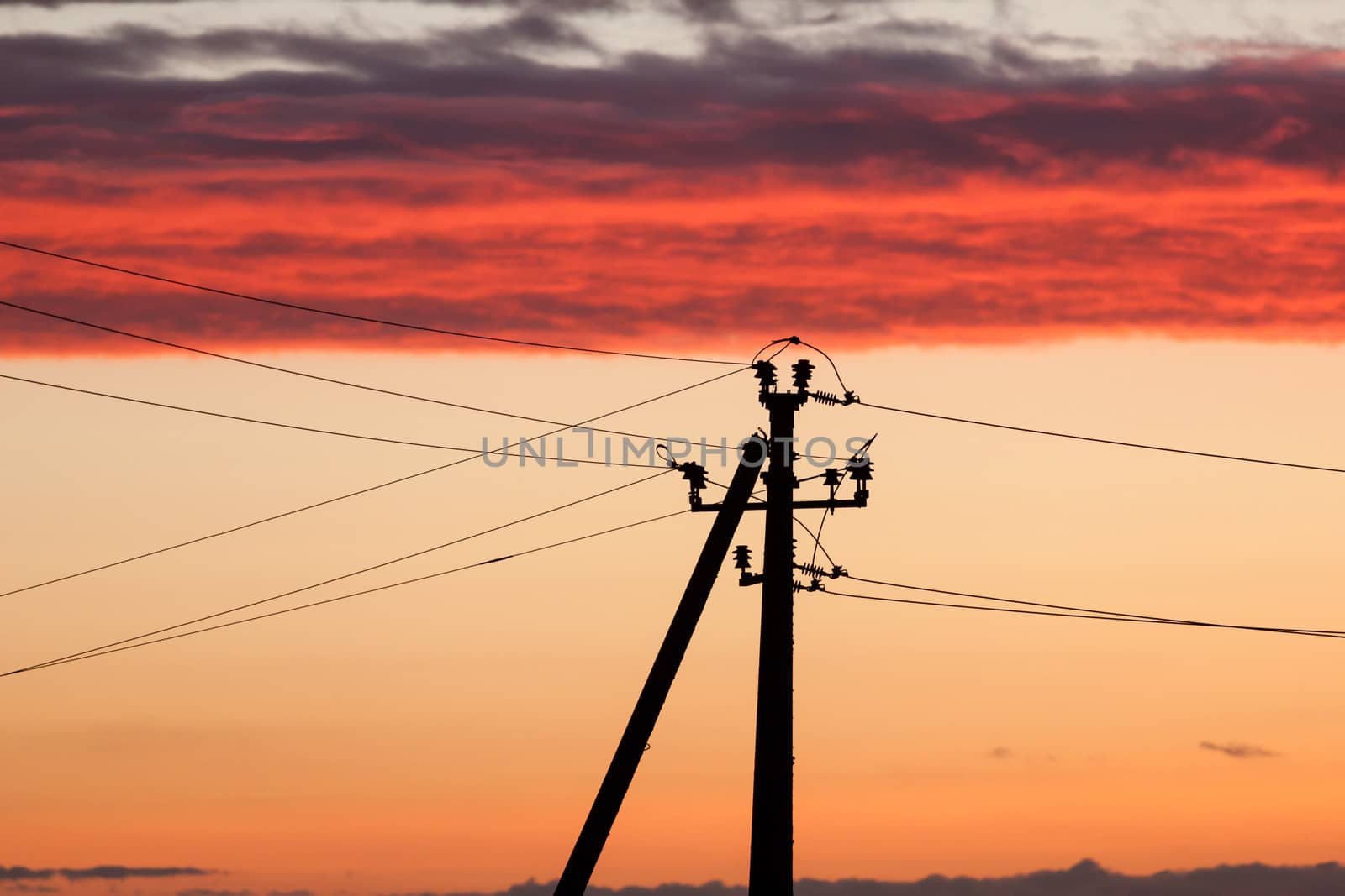 Electric power line against colorful sky at sunset