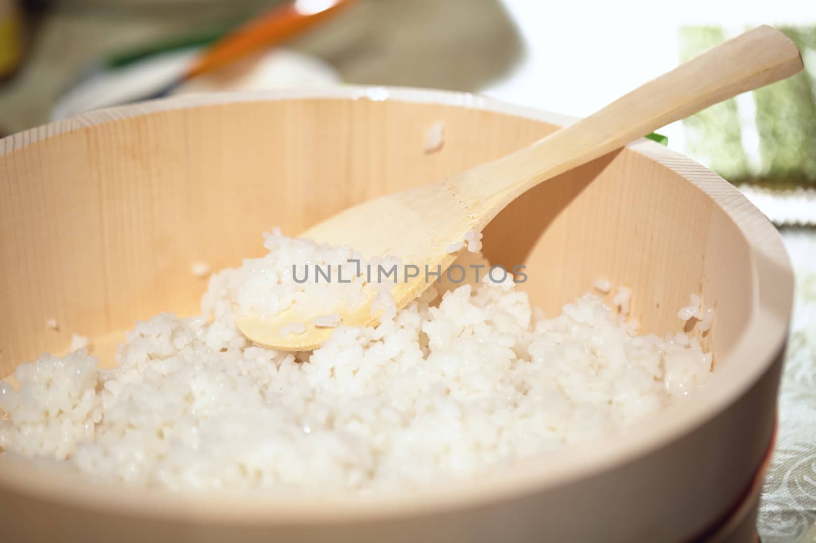 Cooking sushi. Mixing rice in wooden plate. Beautiful macro with shallow dof.