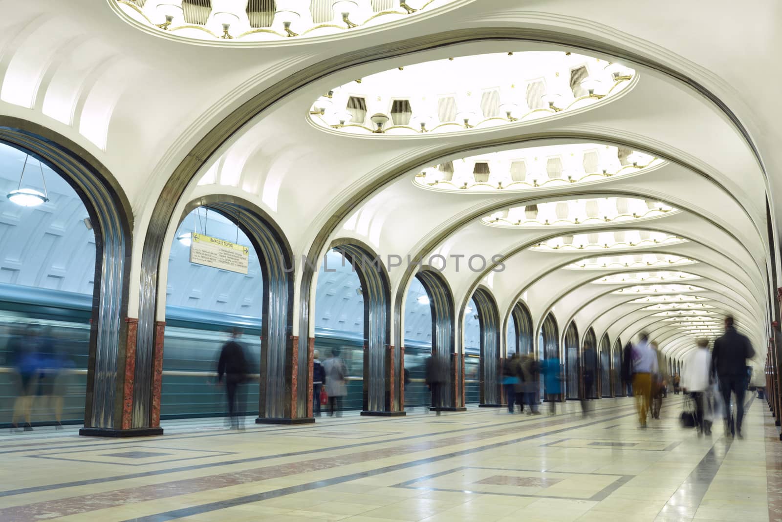 Motion blurred commuters at the metro station. Mayakovskaya station in Moscow underground. Beautiful arch architecture.