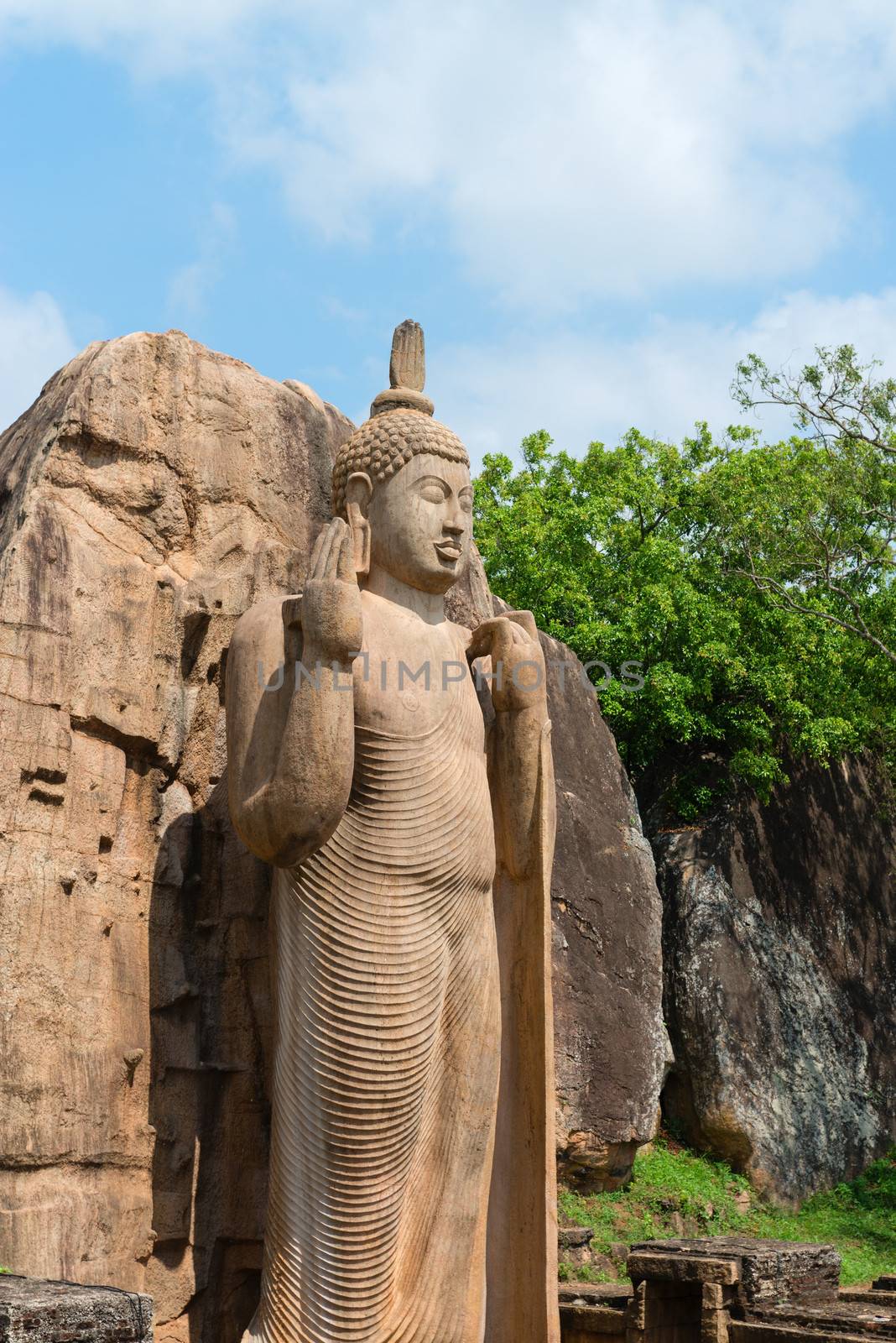 Avukana standing Buddha statue, Sri Lanka. by iryna_rasko
