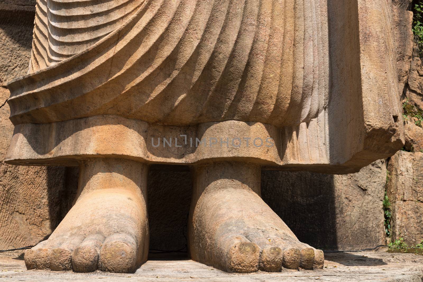 Buddha feet in Avukana standing Buddha statue, Sri Lanka. 40 feet (12 m) high, has been carved out of a large granite rock in the 5th century.