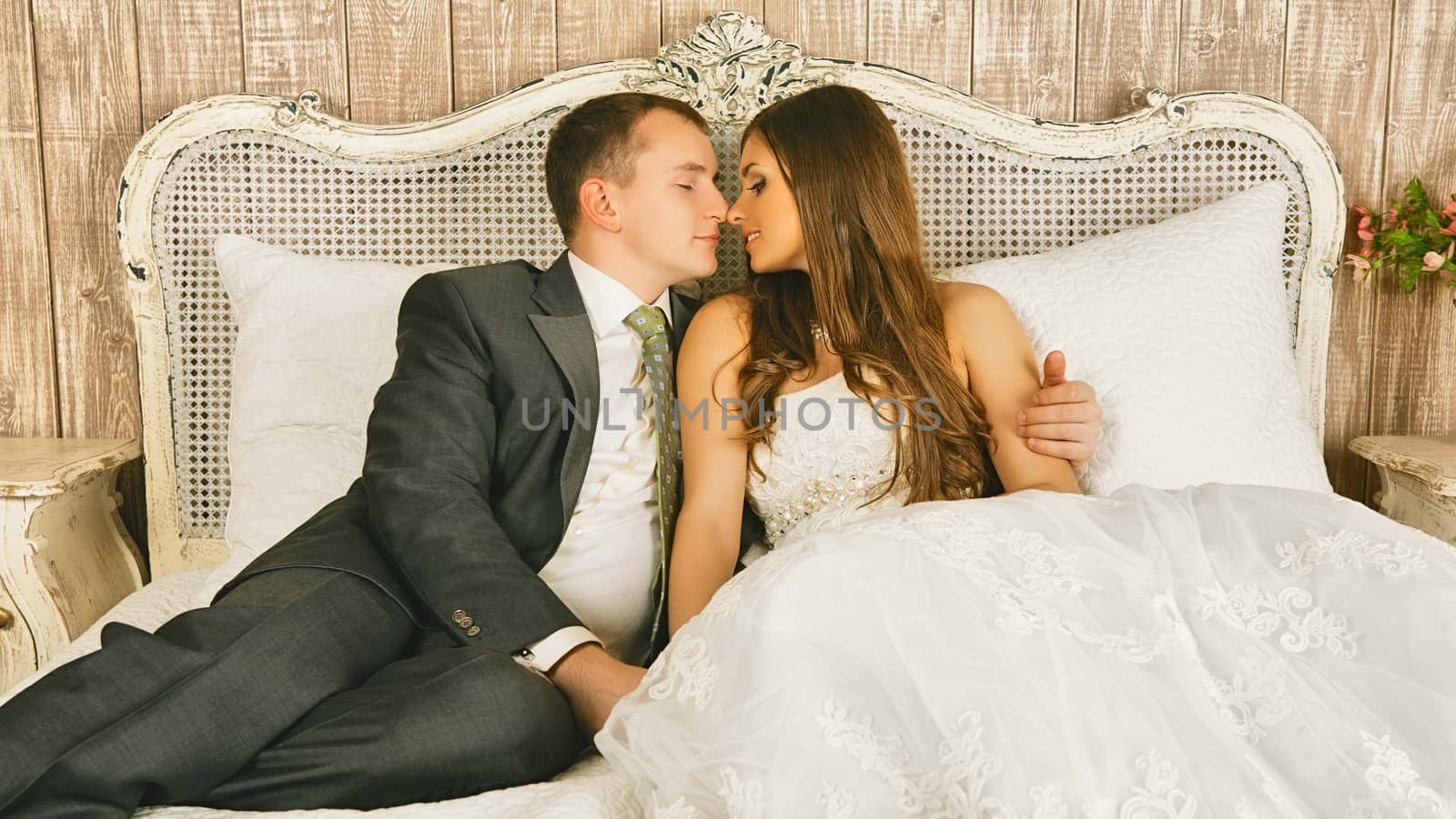 charming bride and groom in their bedroom