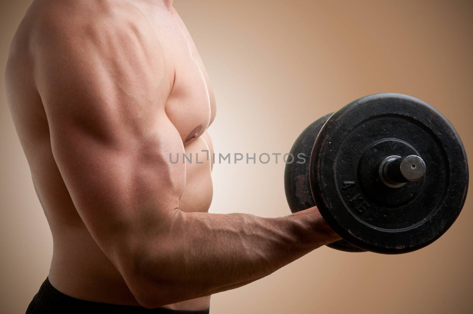 Personal Trainer doing standing dumbbell curls for training his biceps