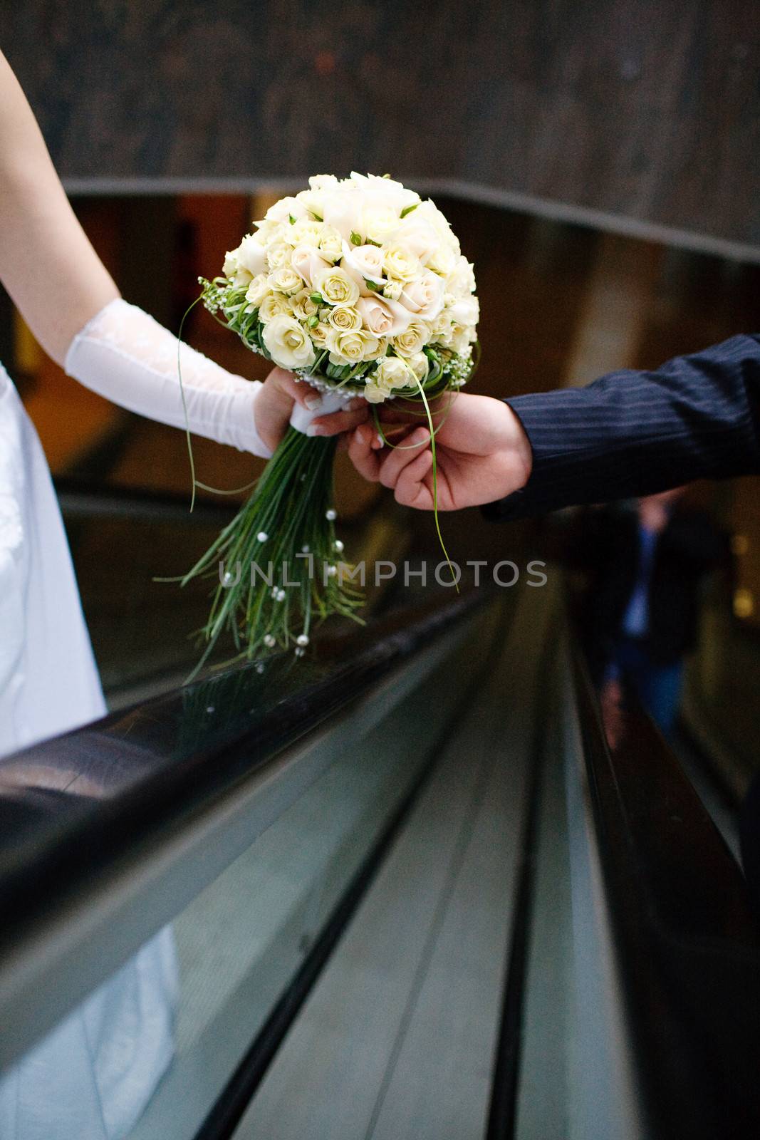 wedding bouquet in hands of the bride and groom