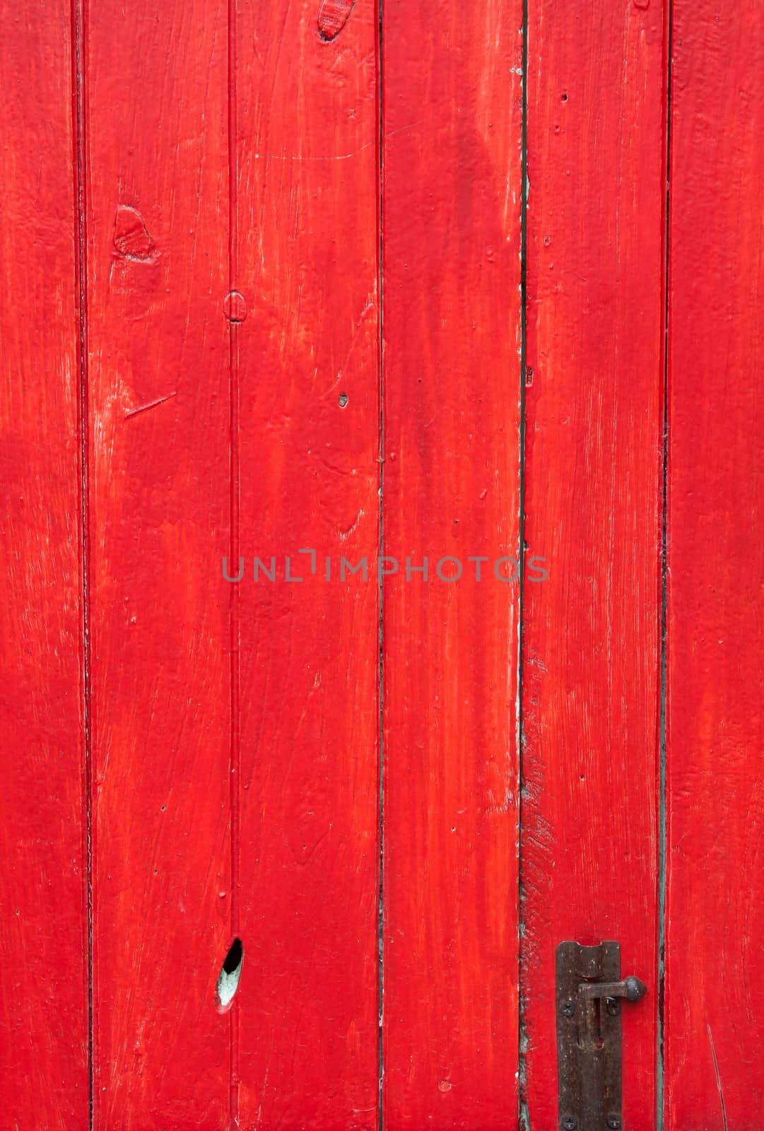 Handmade red painted wooden door with old lock  by punsayaporn