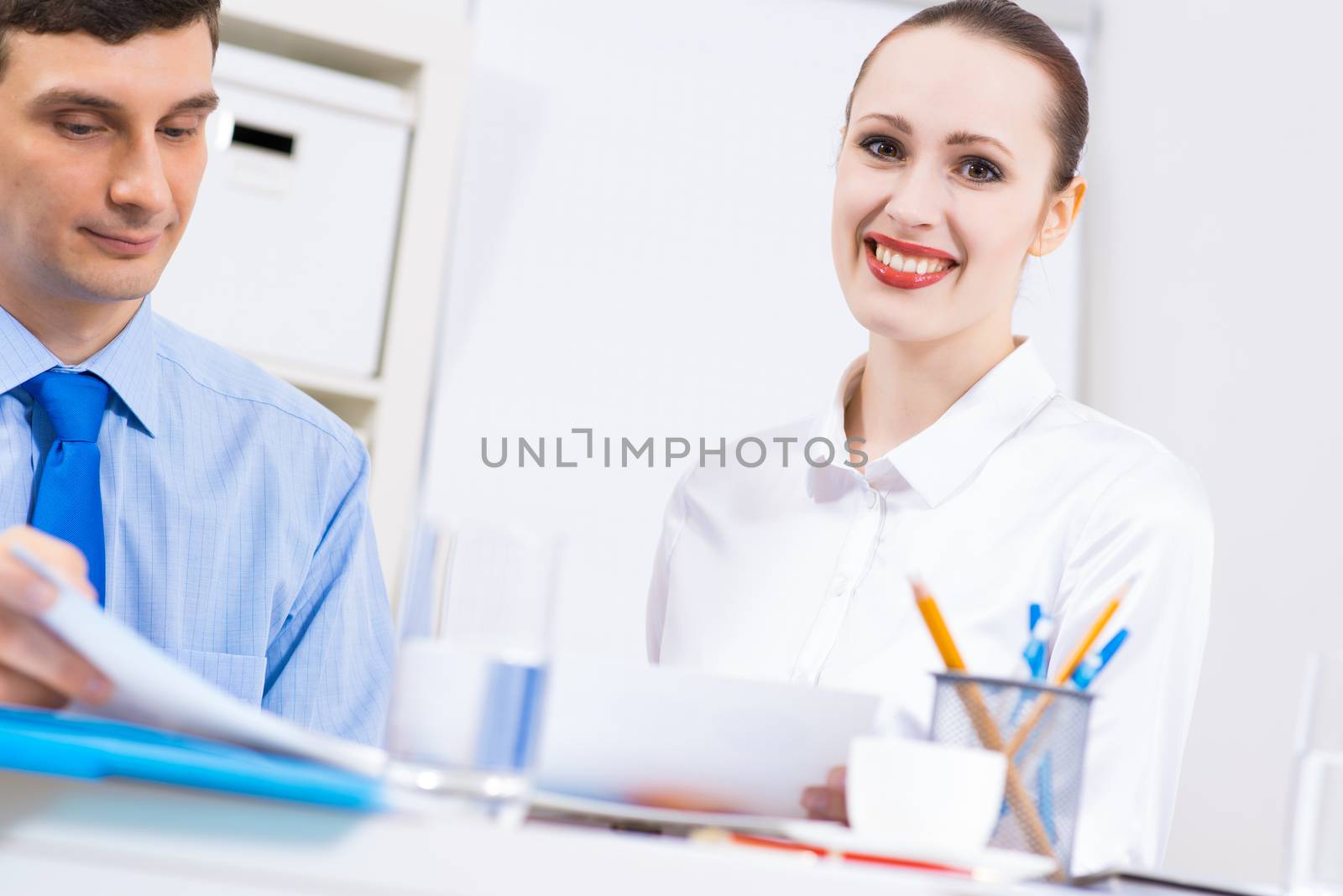 colleagues discuss the reports at a desk in the office, working together in business