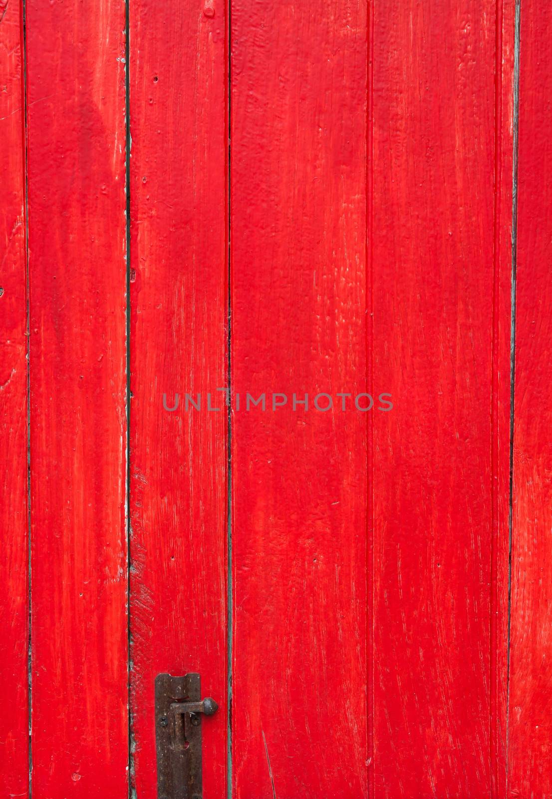 Handmade red painted old wooden door with door lock