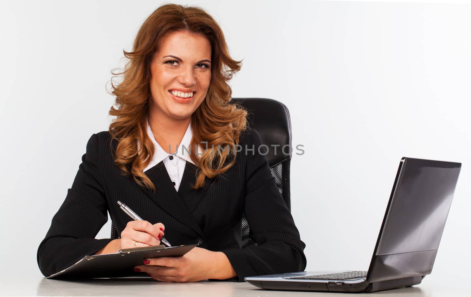 Elegant caucasian woman in suit sitting in the office