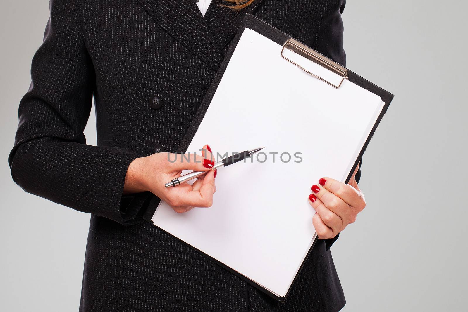 Pen on a blank paper in businesswoman hands with manicure