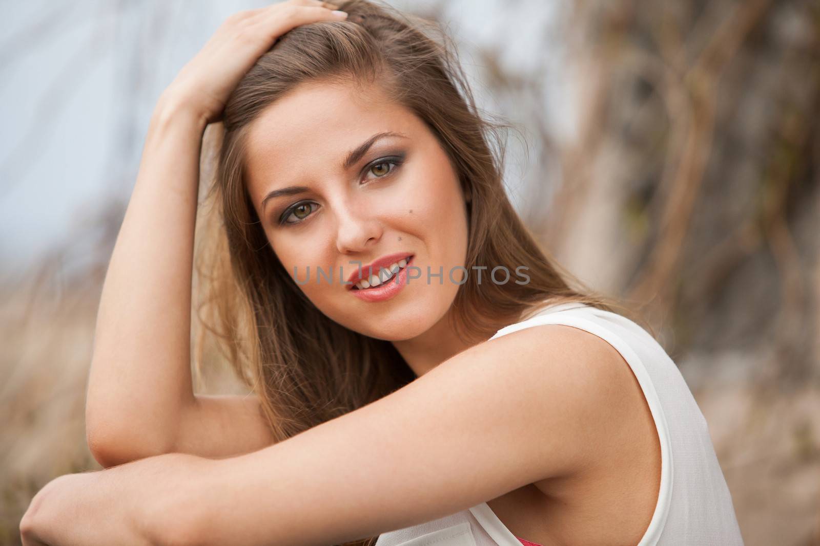 Beautiful caucasian woman in casual sitting next to the old vine