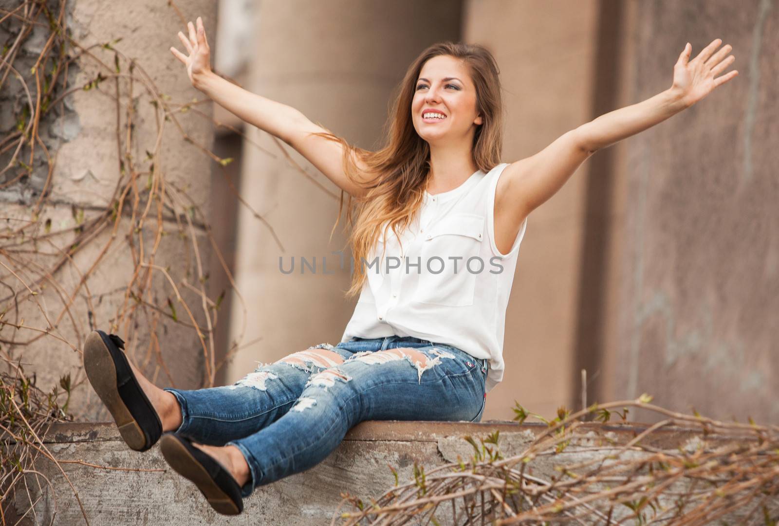 Beautiful caucasian woman in casual sitting next to the old vine with open hands