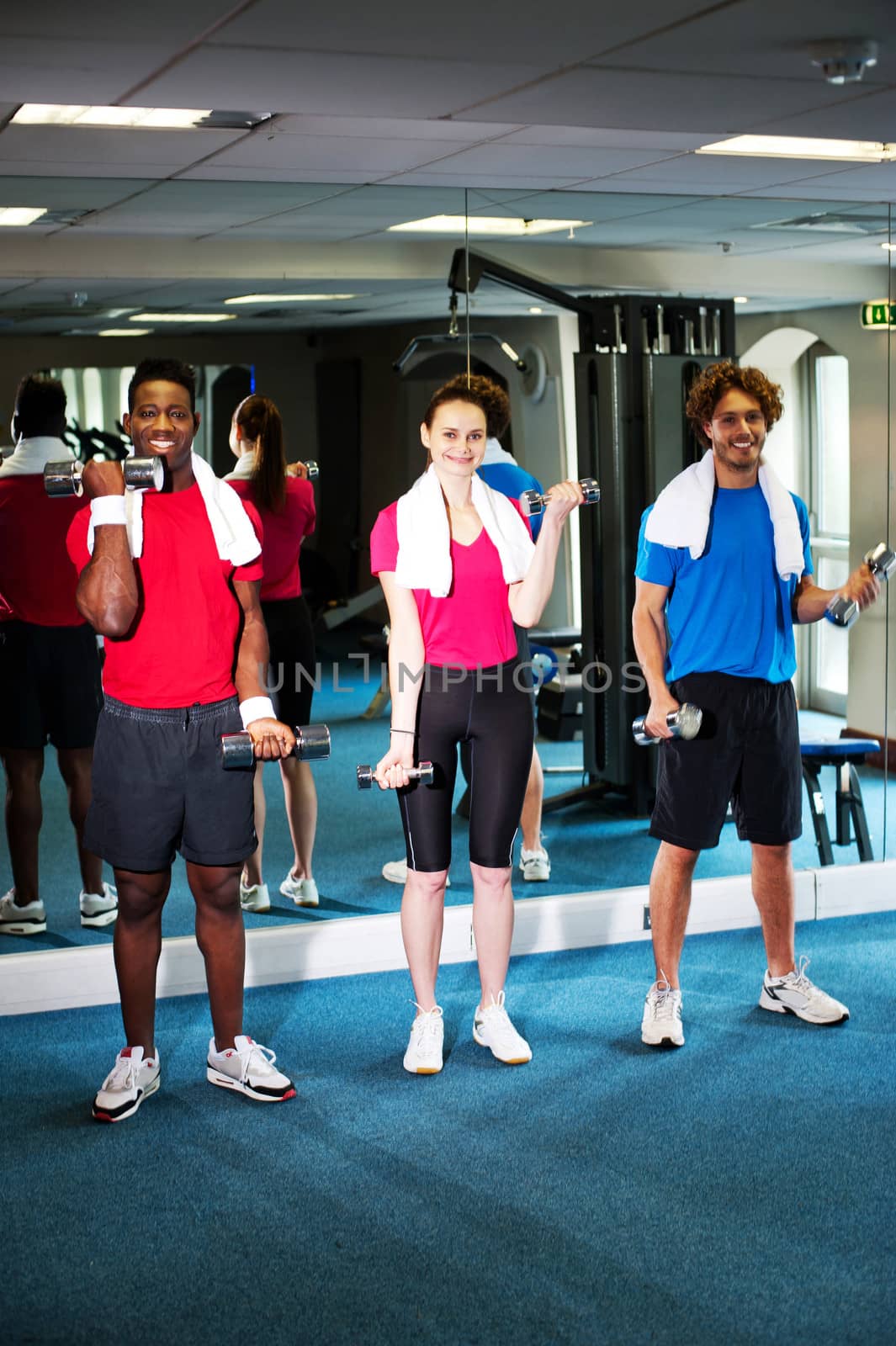 Group of people doing biceps exercise by stockyimages