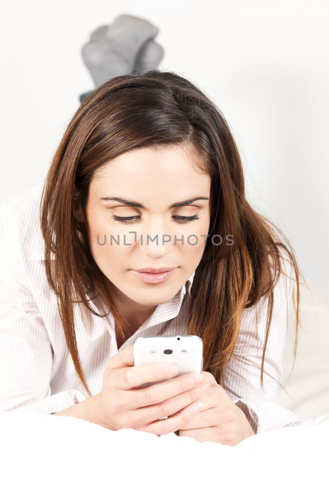 Cute Woman with Smartphone on the Sofa 