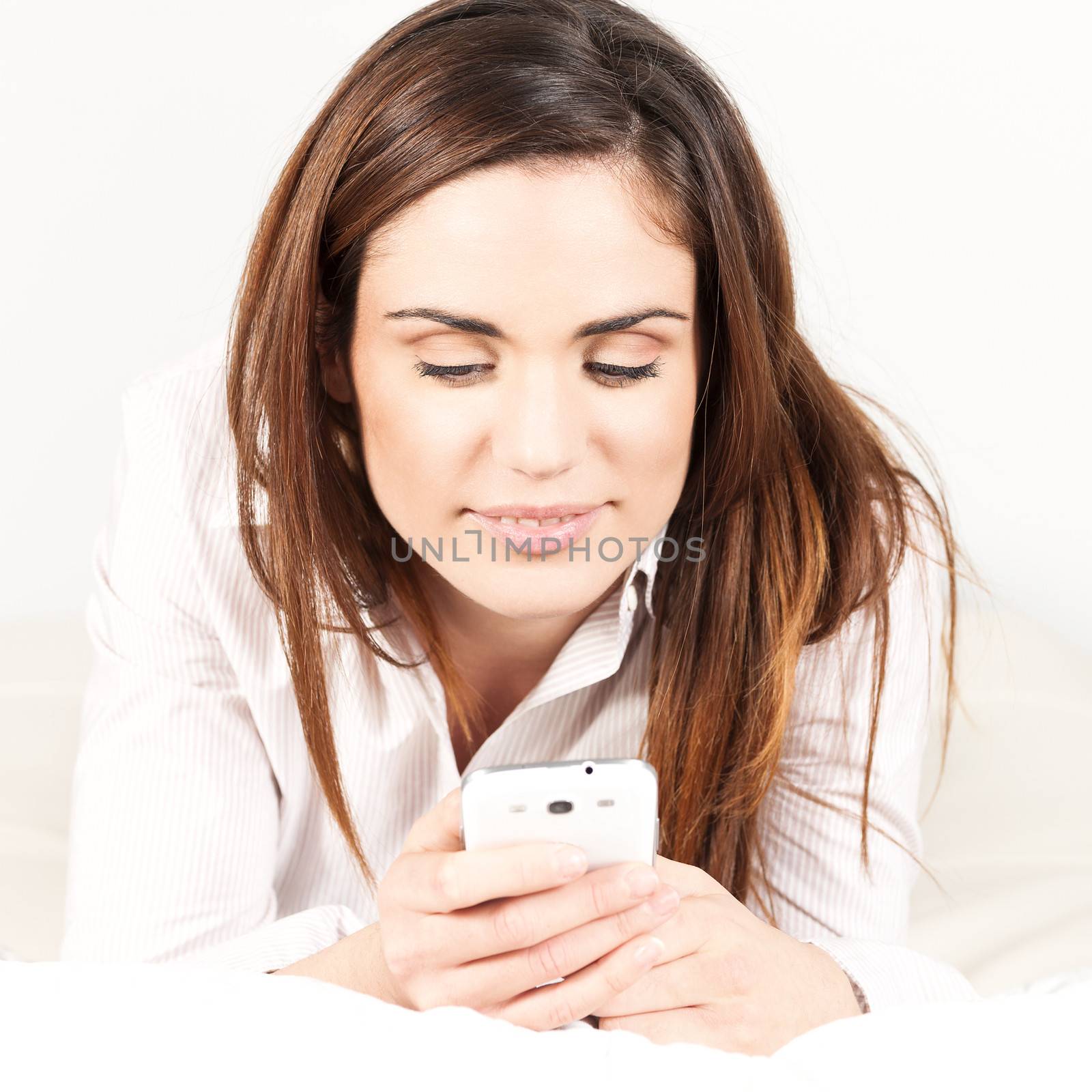 Beautiful Woman with Smartphone on the Sofa 