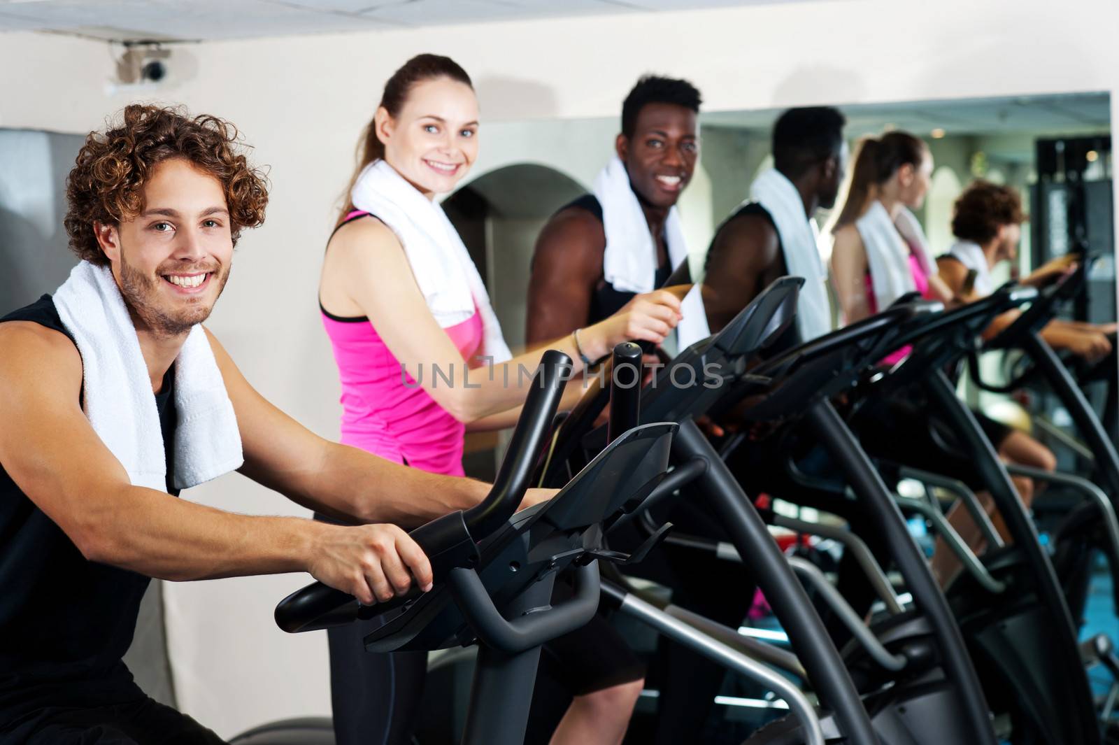 People at gym working out happily by stockyimages