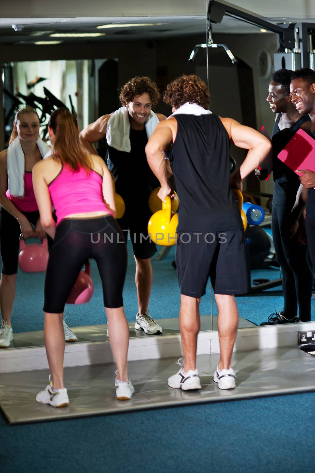 Fitness trainer giving out instructions to people by stockyimages