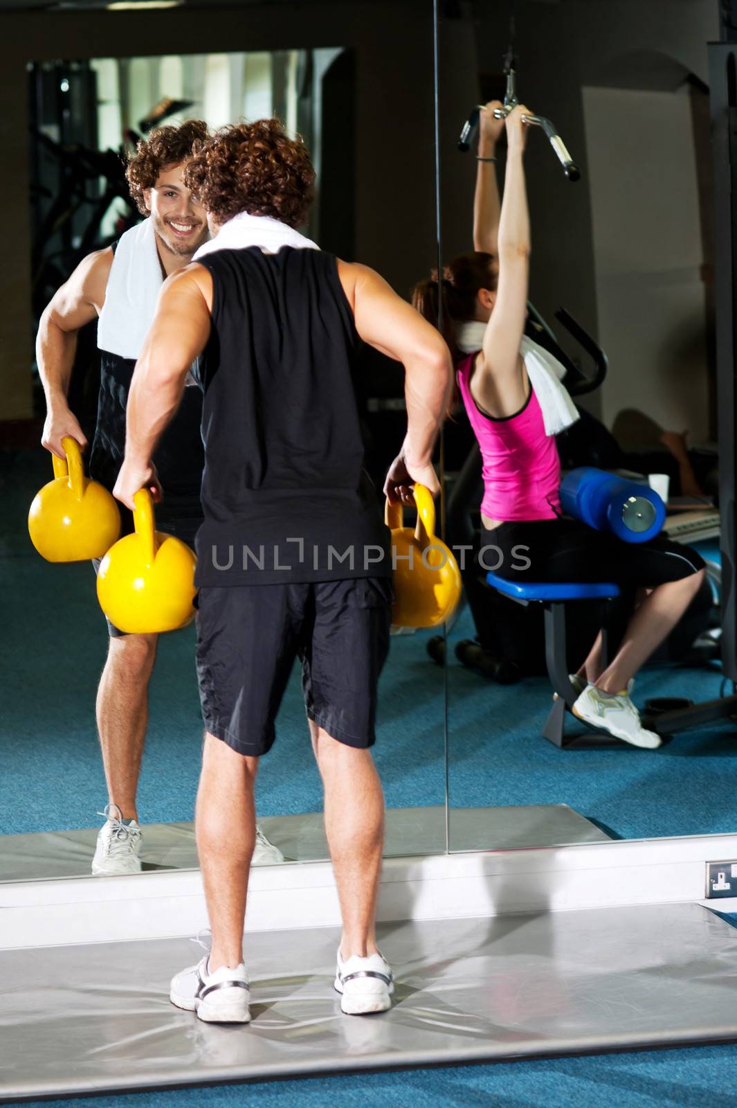 Athletic people working out with equipments by stockyimages