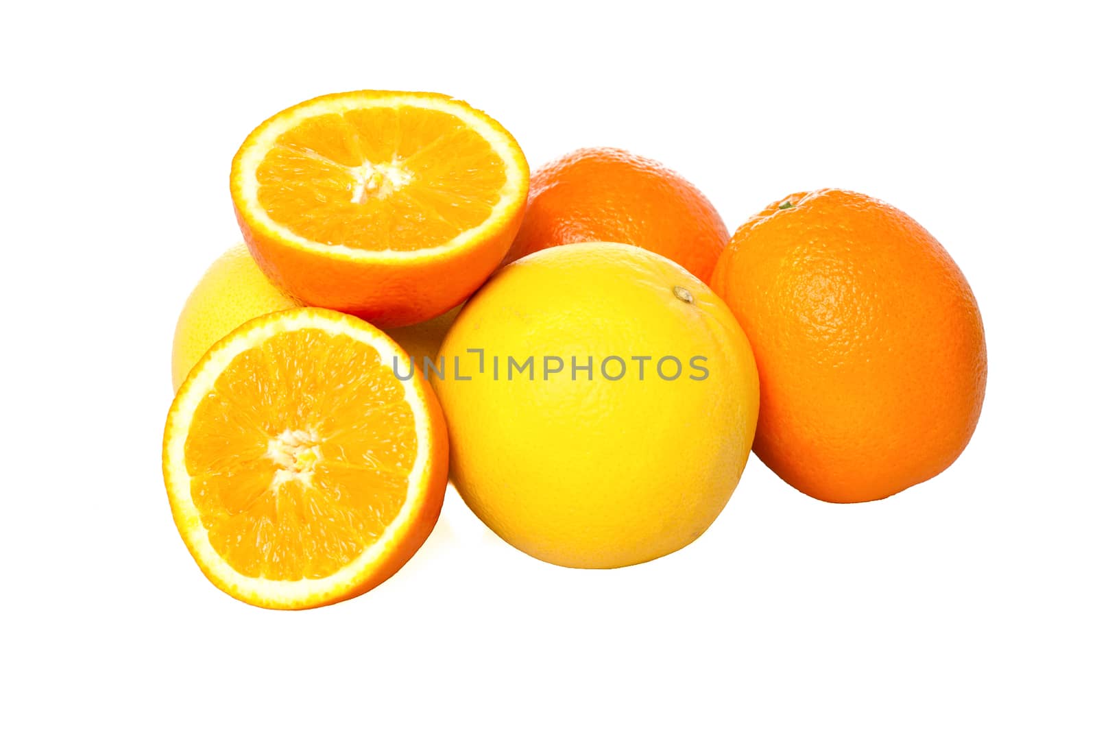 Fresh oranges and sliced grapefruits isolated over white.