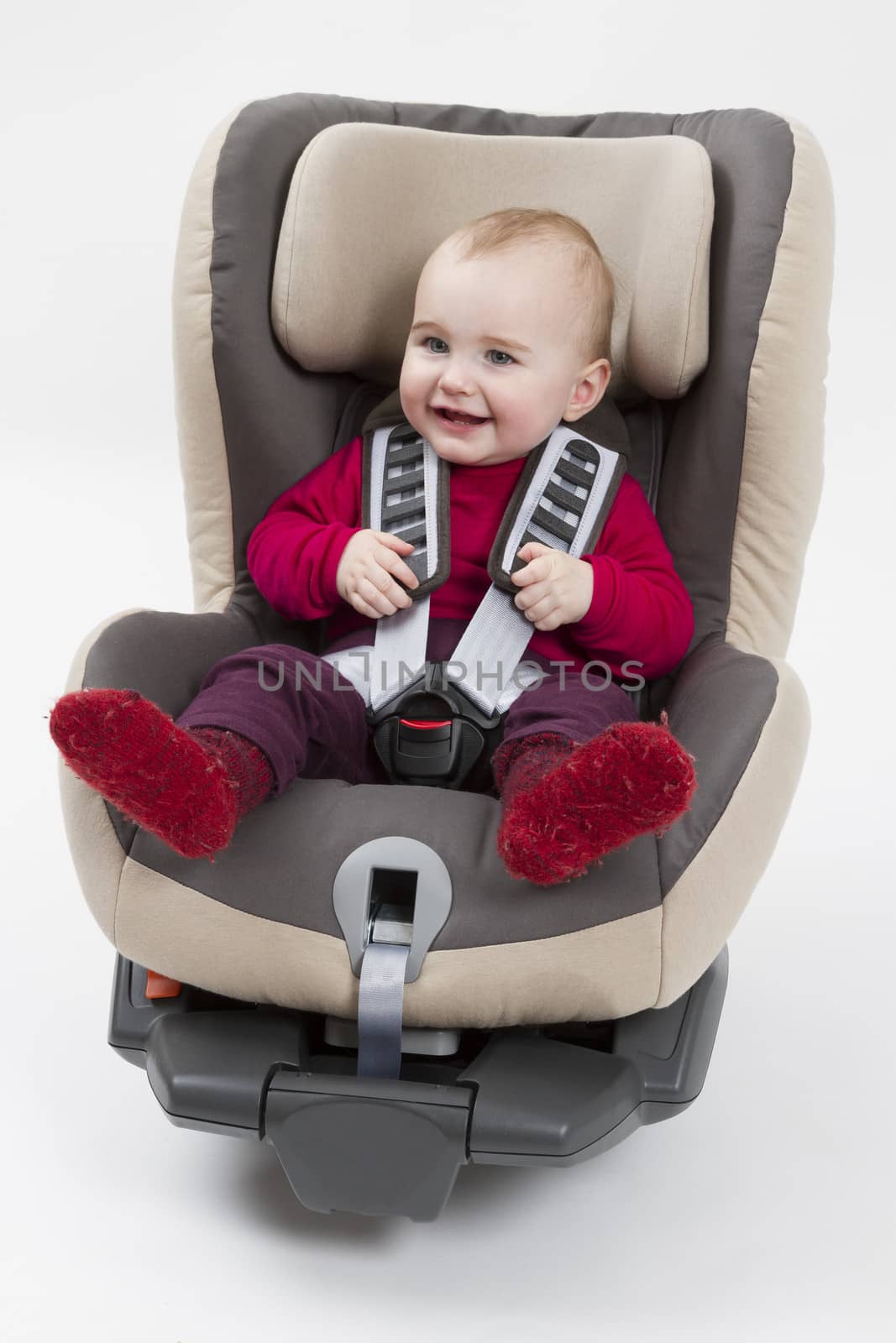 booster seat with child for a car in light background. studio shot