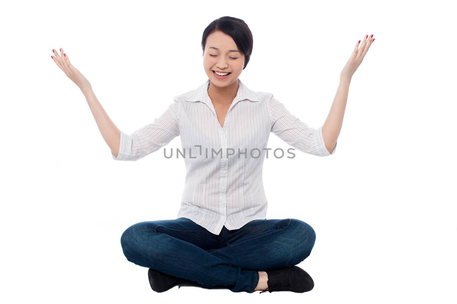 Pretty girl practicing meditation smilingly by stockyimages
