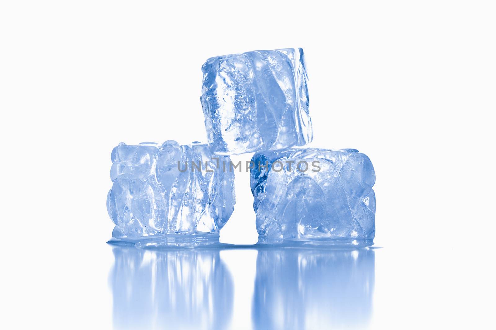 ice cubes shot on reflective white surface