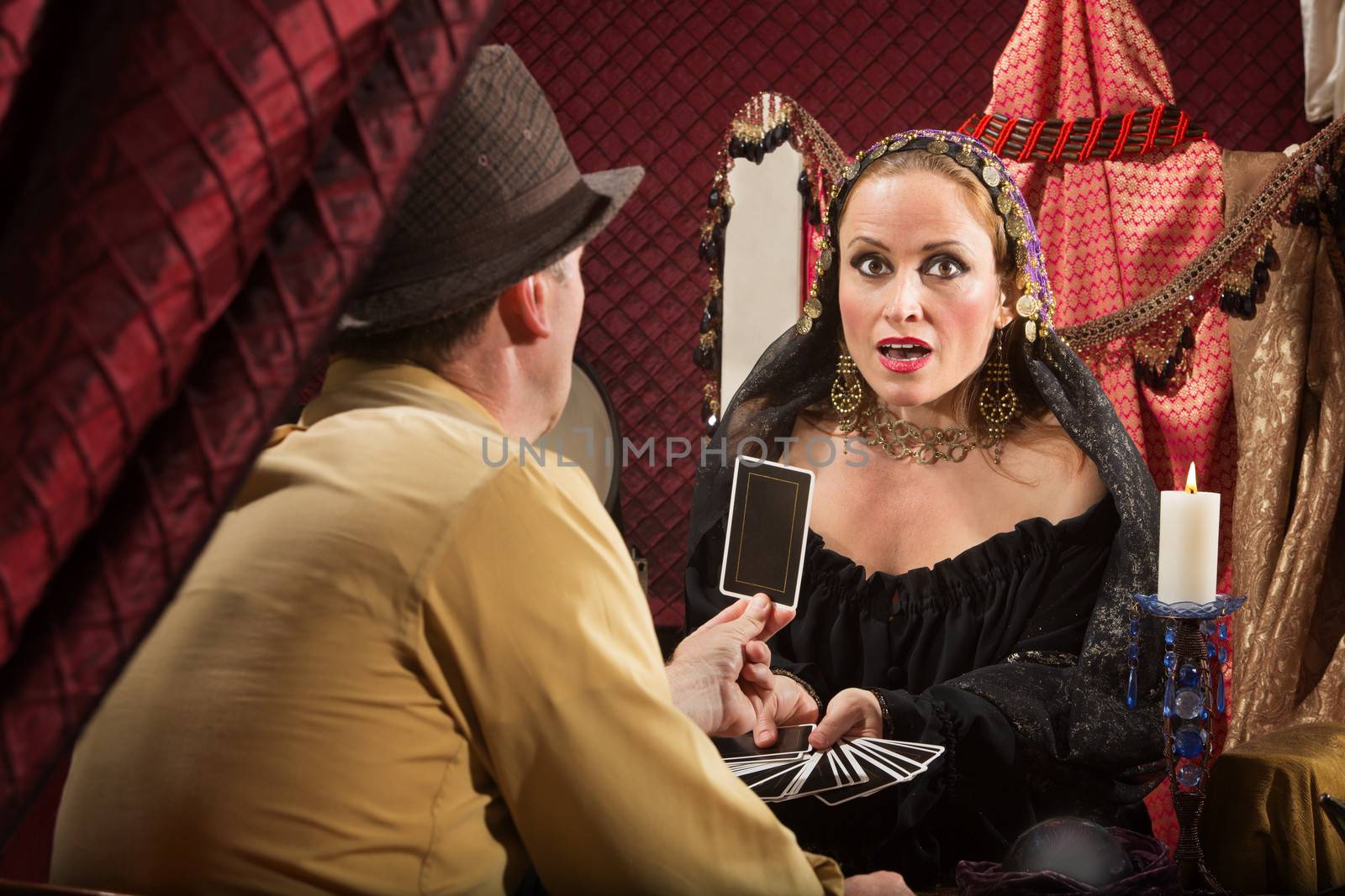 Businessman showing fortune teller his tarot card