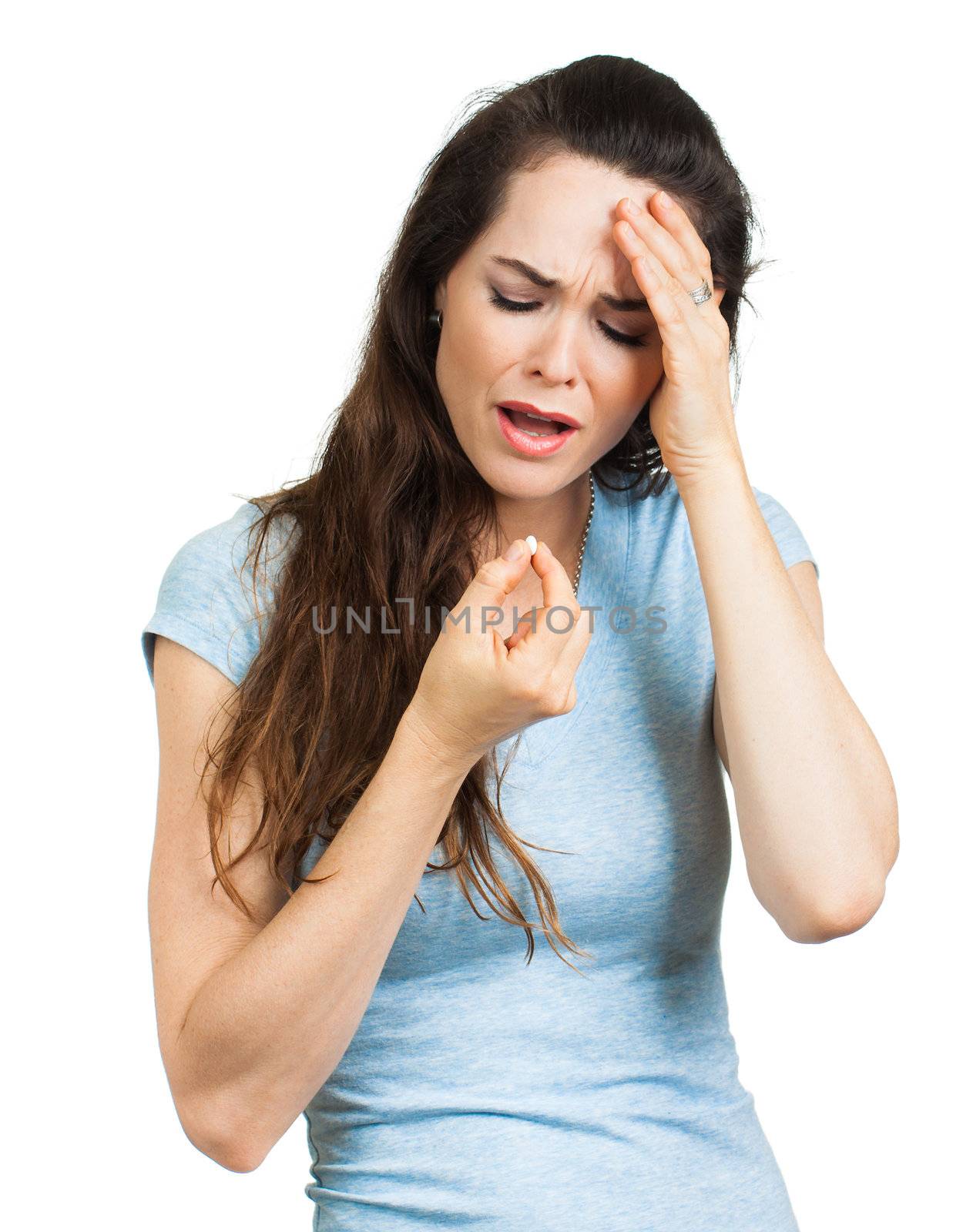 A woman suffering from headache or migraine taking a painkiller pill. Isolated on white.