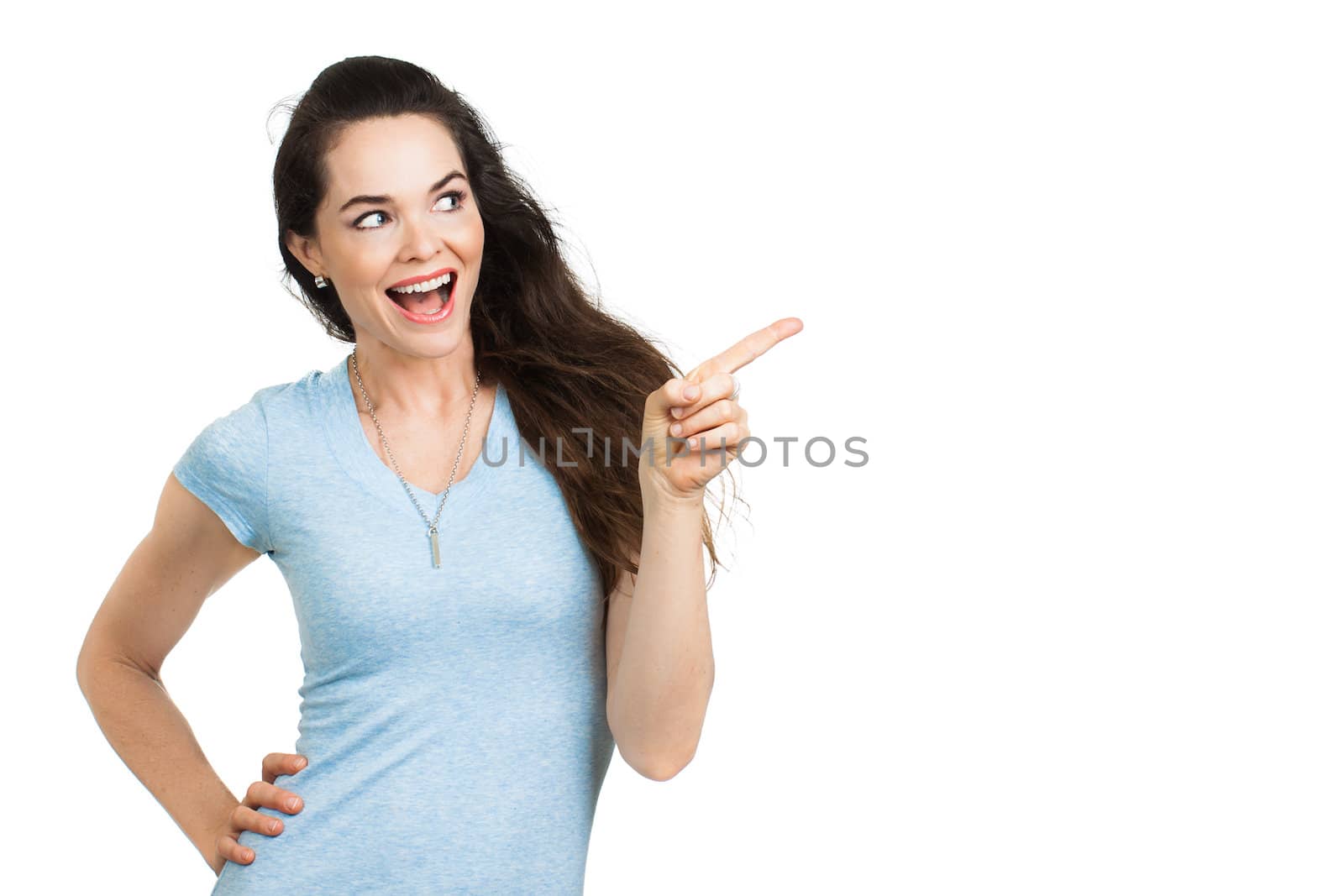 A beautiful happy woman pointing and looking at copy-space. Isolated on white.