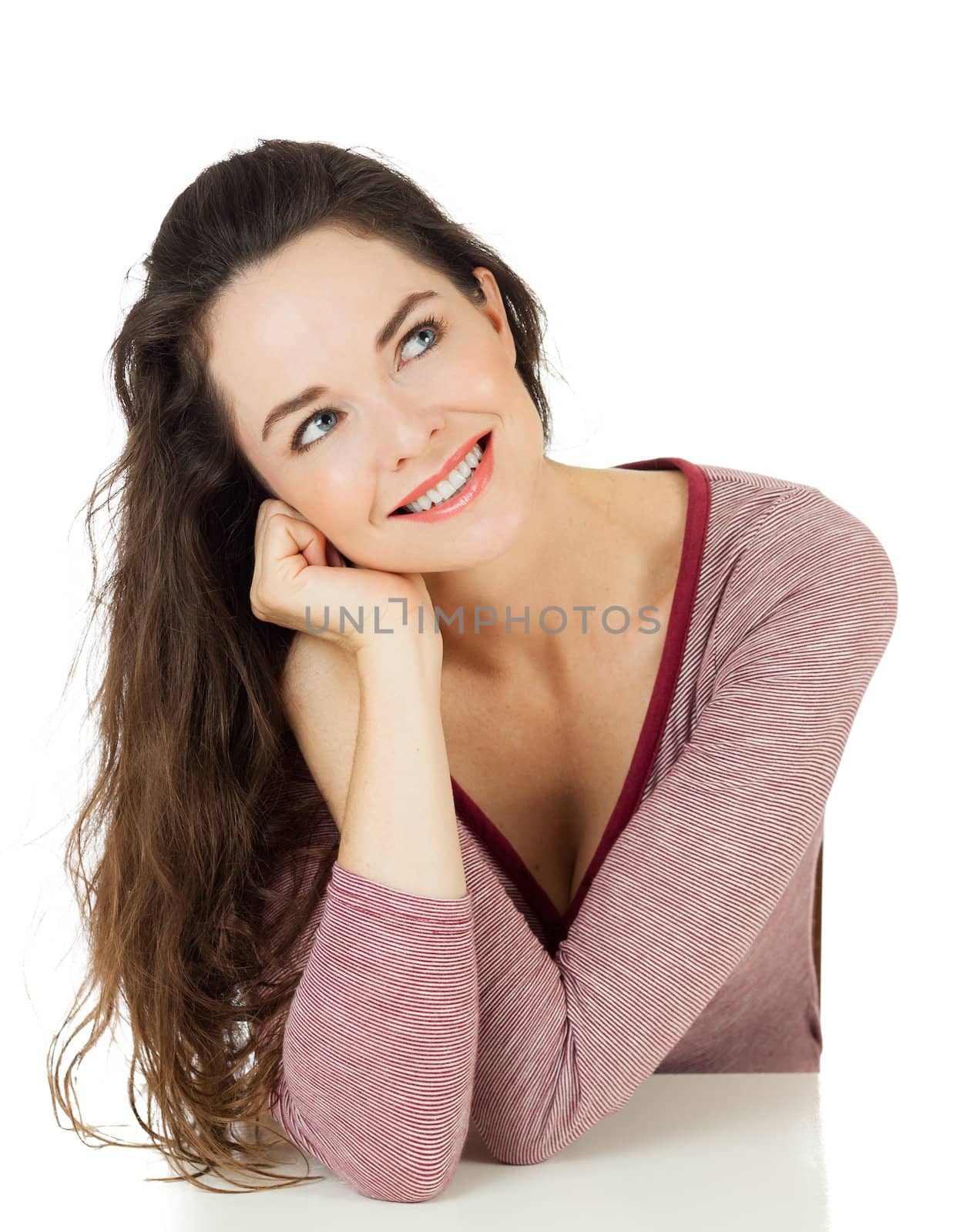 Isolated portrait of an attractive young woman smiling and looking at copyspace.