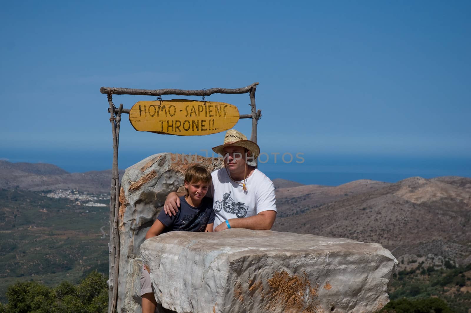 Father and son sit on the throne of mountains in the background. Crit. Greece.